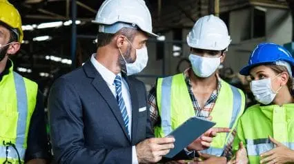 Construction workers using a safety management plan at work on a tablet|Site Safety Management Plan|Site Safety Management Plan Sample Report